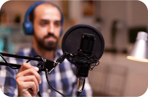 Man recording audio with headphones and a microphone